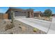 Attractive home exterior with desert landscaping, low-maintenance gravel, and a well-kept driveway at 18746 W Rancho Dr, Litchfield Park, AZ 85340