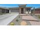 Inviting single-Gathering home showcasing desert landscaping, a neutral color scheme, and an attached two-car garage at 18746 W Rancho Dr, Litchfield Park, AZ 85340