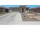 Charming single-story home featuring desert landscaping, a two-car garage, and a brick-accented entryway at 18746 W Rancho Dr, Litchfield Park, AZ 85340