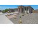 Charming home featuring desert landscaping with cacti and decorative stone accents, complemented by a stone pillar entryway at 18746 W Rancho Dr, Litchfield Park, AZ 85340