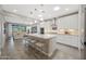 Open-concept kitchen with a large island and stainless steel appliances at 18746 W Rancho Dr, Litchfield Park, AZ 85340