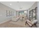 Bright living room featuring a comfortable sectional sofa, stylish decor, and seamless access to the outdoor space at 18746 W Rancho Dr, Litchfield Park, AZ 85340