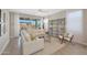 Inviting living room with plush seating, a modern bookshelf, and sliding glass doors leading to a covered patio at 18746 W Rancho Dr, Litchfield Park, AZ 85340