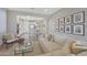 Cozy living room with seamless layout to kitchen featuring comfortable seating and charming decor at 18746 W Rancho Dr, Litchfield Park, AZ 85340