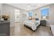 Bright bedroom with large windows, stylish decor, and ensuite bathroom at 18746 W Rancho Dr, Litchfield Park, AZ 85340