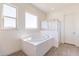 A modern bathroom with a soaking tub and glass-enclosed shower at 18938 W Ocotillo Rd, Waddell, AZ 85355