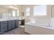 A luxurious bathroom featuring a soaking tub, double vanity, and separate shower at 18938 W Ocotillo Rd, Waddell, AZ 85355