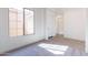 Bright bedroom with a neutral color palette, plush carpeting, and a large window offering ample natural light at 18938 W Ocotillo Rd, Waddell, AZ 85355