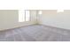 A bright bedroom with carpet flooring and a large window at 18938 W Ocotillo Rd, Waddell, AZ 85355