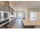 A kitchen with an island, gray cabinets, stainless steel appliances, and a dining area at 18938 W Ocotillo Rd, Waddell, AZ 85355