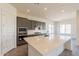 A kitchen with a large island, gray cabinets, stainless steel appliances, and white backsplash at 18938 W Ocotillo Rd, Waddell, AZ 85355