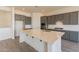 Spacious kitchen with grey cabinets, stainless steel appliances, large island, and ample counter space at 18938 W Ocotillo Rd, Waddell, AZ 85355