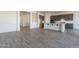 Open-concept kitchen and living room showcasing the layout and modern finishes with beautiful flooring at 18938 W Ocotillo Rd, Waddell, AZ 85355