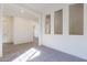 A spacious living room with modern flooring, neutral walls, and abundant natural light at 18938 W Ocotillo Rd, Waddell, AZ 85355
