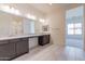 Bathroom boasts double sinks, a large mirror, and lots of storage at 18950 W Ocotillo Rd, Waddell, AZ 85355