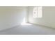 Sunlit, carpeted bedroom features neutral walls and a bright window at 18950 W Ocotillo Rd, Waddell, AZ 85355