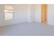 Bright bedroom features neutral carpet, a window, and an ensuite bathroom at 18950 W Ocotillo Rd, Waddell, AZ 85355