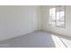 Carpeted bedroom features natural light from a large window at 18950 W Ocotillo Rd, Waddell, AZ 85355
