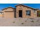 Charming stone-accented home with a two-car garage and a paved driveway at 18950 W Ocotillo Rd, Waddell, AZ 85355