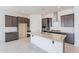 Modern kitchen with granite countertops, white subway tile backsplash, and island sink at 18950 W Ocotillo Rd, Waddell, AZ 85355