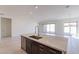 Bright kitchen island with stainless steel sink, granite countertops, and modern cabinetry at 18950 W Ocotillo Rd, Waddell, AZ 85355