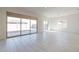 Bright living room featuring large sliding glass doors and neutral tile flooring at 18950 W Ocotillo Rd, Waddell, AZ 85355