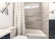 Bright bathroom with tub and shower featuring marbled tile surround and nautical decor at 19413 N 8Th St, Phoenix, AZ 85024