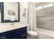 Stylish bathroom featuring marble-look tiles, modern vanity, and bathtub with shower at 19413 N 8Th St, Phoenix, AZ 85024