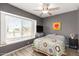 Comfortable bedroom featuring a ceiling fan, window, and stylish decor for relaxed living at 19413 N 8Th St, Phoenix, AZ 85024