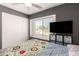 Bedroom showcasing a window, ceiling fan, and closet for comfort and convenience at 19413 N 8Th St, Phoenix, AZ 85024