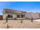 Front exterior of home with solar panels, a two-car garage, and low-maintenance desert landscaping at 19413 N 8Th St, Phoenix, AZ 85024