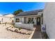 Charming home with front patio and seating area, low-maintenance desert landscaping, and solar panels at 19413 N 8Th St, Phoenix, AZ 85024