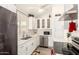 Well-lit kitchen featuring white cabinets, quartz countertops, stainless steel appliances, and a view of the window at 19413 N 8Th St, Phoenix, AZ 85024
