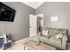 Cozy living room with gray walls, mounted television, and comfortable green sofa at 19413 N 8Th St, Phoenix, AZ 85024