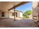 Expansive covered patio featuring a cozy outdoor fireplace and paved flooring at 20139 E Via Del Oro --, Queen Creek, AZ 85142