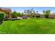 Lush backyard with vibrant green grass, a built in grill, and well-manicured landscaping at 20139 E Via Del Oro --, Queen Creek, AZ 85142