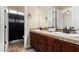 Bathroom with dual sink vanity, updated fixtures, tile backsplash, and a shower and tub at 20139 E Via Del Oro --, Queen Creek, AZ 85142