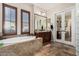 Luxurious bathroom featuring a soaking tub, dark wood cabinets, and lots of natural light at 20139 E Via Del Oro --, Queen Creek, AZ 85142