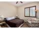 Cozy bedroom featuring an accent chair, ceiling fan and lots of natural light at 20139 E Via Del Oro --, Queen Creek, AZ 85142