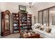 Living room featuring bookshelves and a grandfather clock at 20139 E Via Del Oro --, Queen Creek, AZ 85142