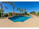 Refreshing pool with palm trees, lush landscaping, and clear blue skies, perfect for outdoor relaxation at 20139 E Via Del Oro --, Queen Creek, AZ 85142