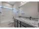 Bathroom featuring double sinks, granite countertops, and a shower-tub combo at 20234 W Catalina Dr, Buckeye, AZ 85396
