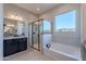 This primary bathroom features dual sinks, a stand-up shower, and soaking tub at 20234 W Catalina Dr, Buckeye, AZ 85396