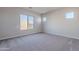 This spacious bedroom is bright with 3 windows and neutral colored carpet flooring at 20234 W Catalina Dr, Buckeye, AZ 85396