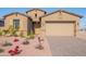 Charming single-story home with tan stucco, beautiful landscaping, and a brick paved driveway at 20234 W Catalina Dr, Buckeye, AZ 85396