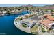 Aerial view features waterfront property, lush landscaping, a sparkling pool, and mountain views at 21663 N 57Th Ave, Glendale, AZ 85308