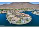 Picture perfect aerial view of multiple waterfront homes with shimmering waters and community streets at 21663 N 57Th Ave, Glendale, AZ 85308