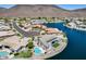Beautiful aerial view of a waterfront property featuring a sparkling pool and manicured lawn at 21663 N 57Th Ave, Glendale, AZ 85308