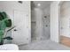 Bright bathroom featuring a glass shower, white tile, and a stylish tropical plant for a spa-like feel at 21663 N 57Th Ave, Glendale, AZ 85308