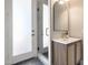 Bathroom featuring a glass enclosed shower, stone floors, and a wooden vanity at 21663 N 57Th Ave, Glendale, AZ 85308